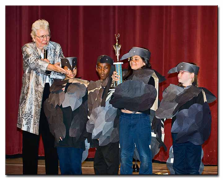Nancy DeStefanis presenting the first place trophy to the Common Ravens